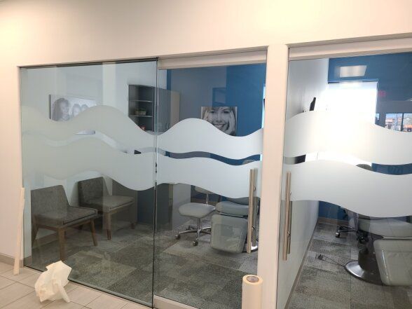 a waiting room with frosted glass doors