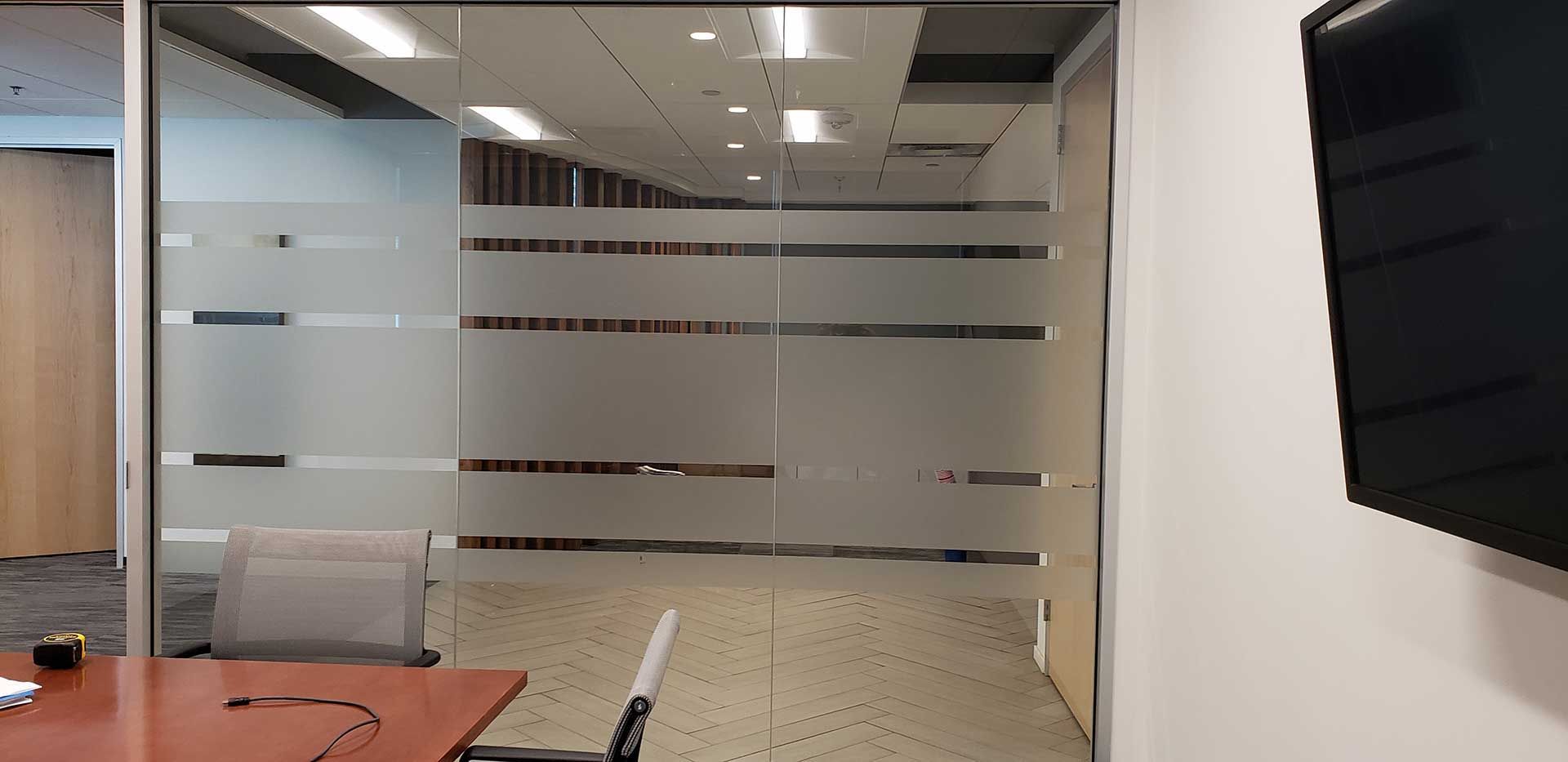 a conference room with a frosted glass wall