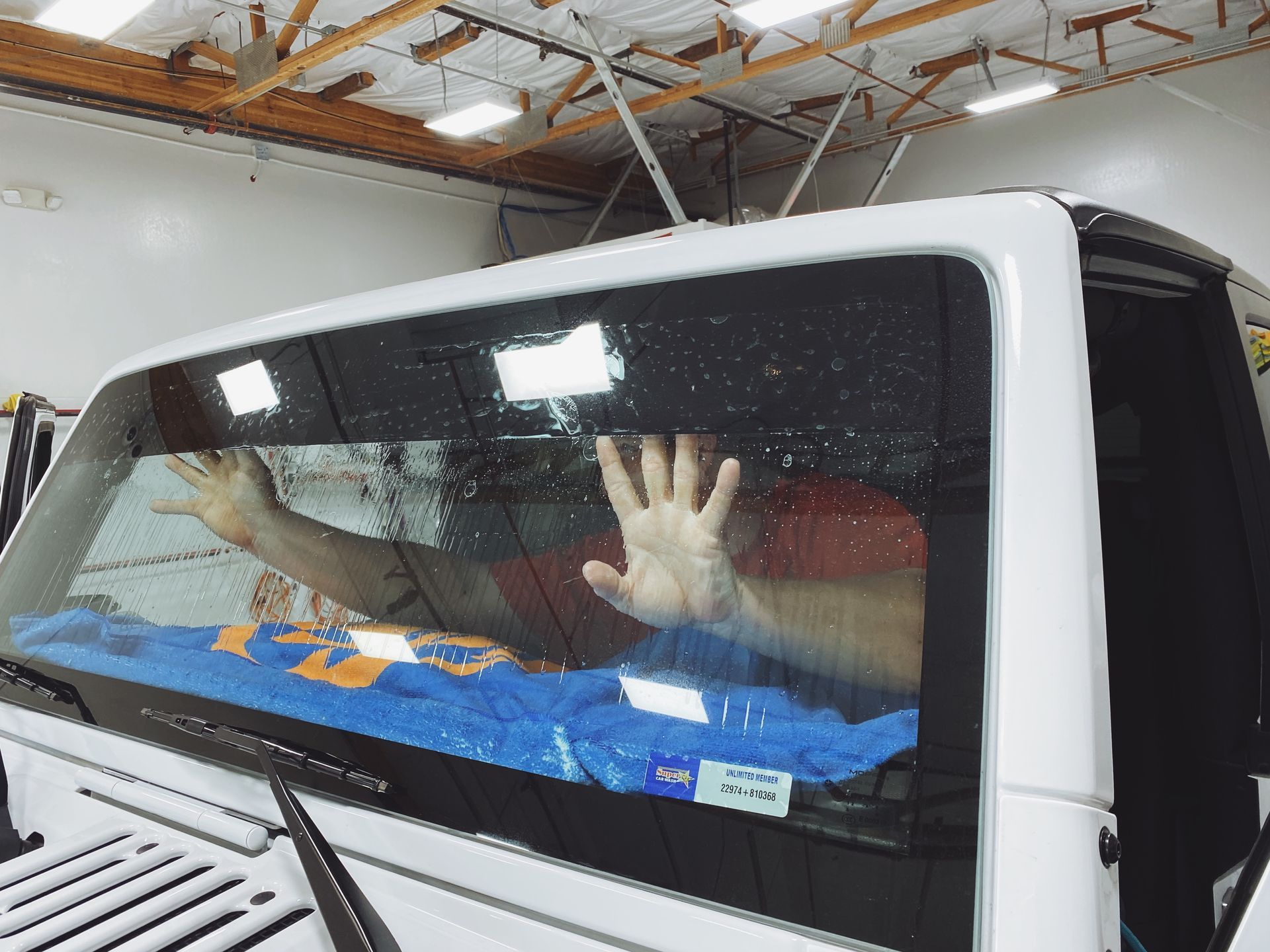 a person is installing tin on a car's windshield