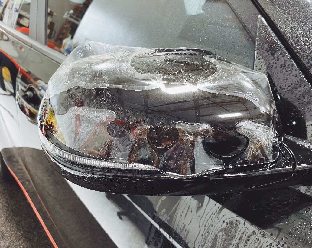 a close up of a car 's rear view mirror covered in protective film