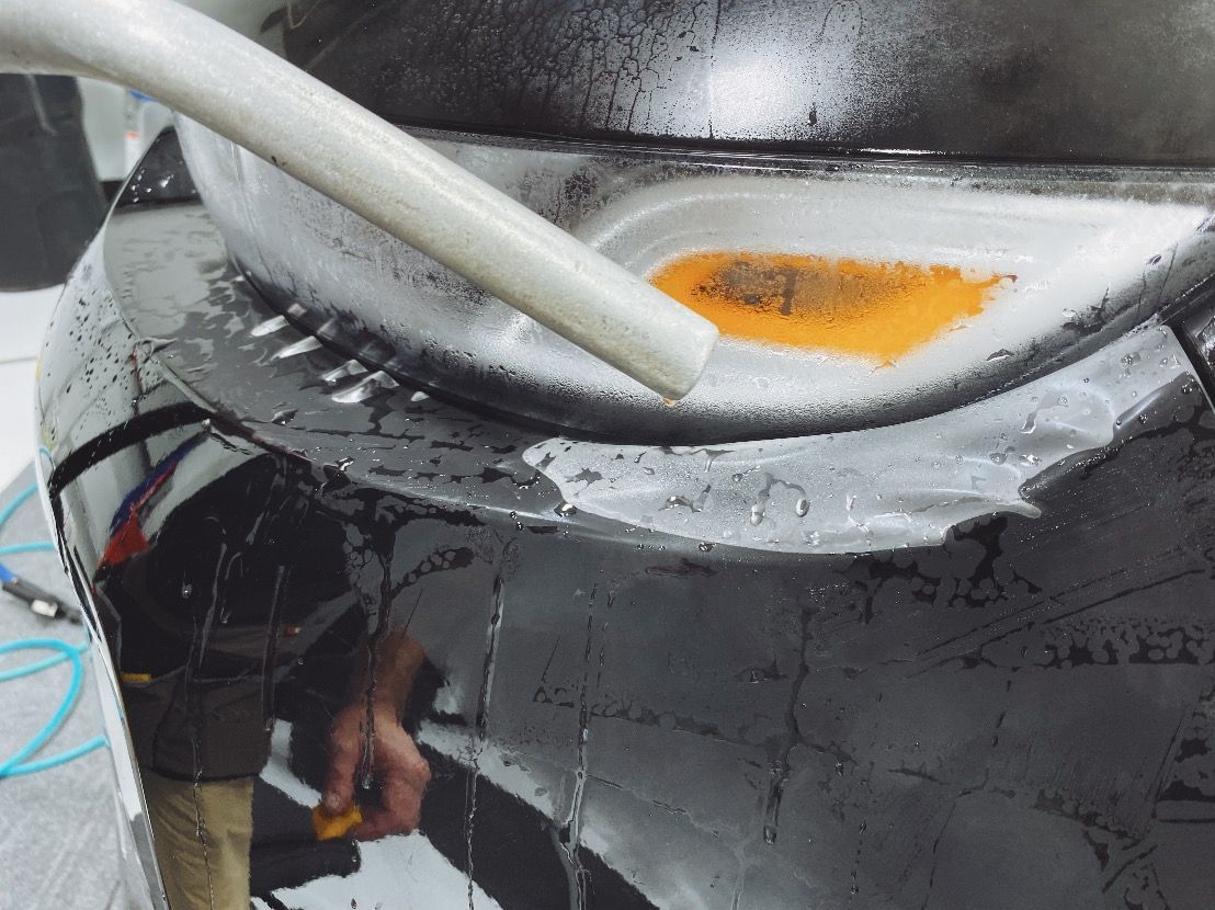 protective film installation on a black car