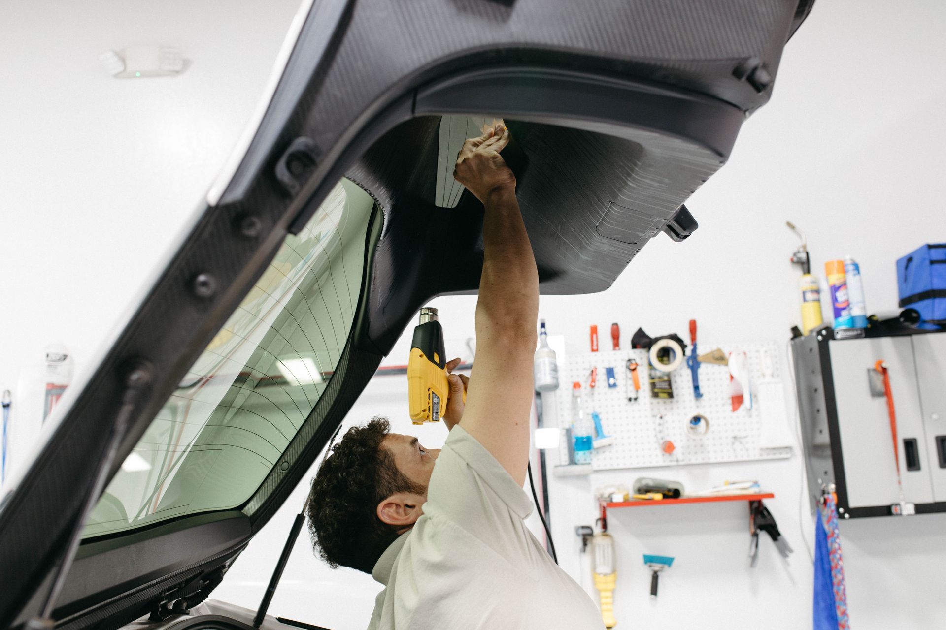 a man is installing tint on a car