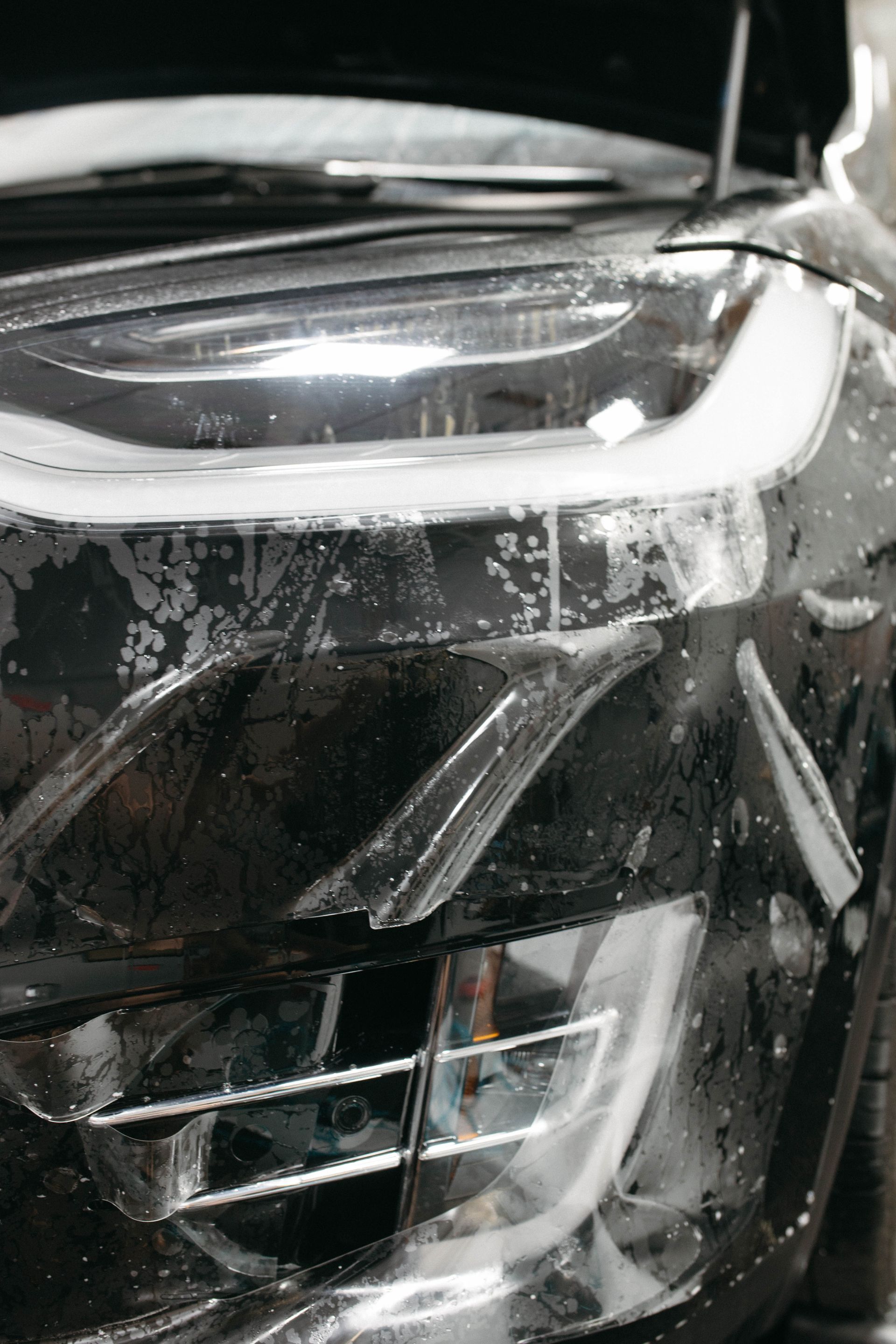 a close up of a car with a protective film on it