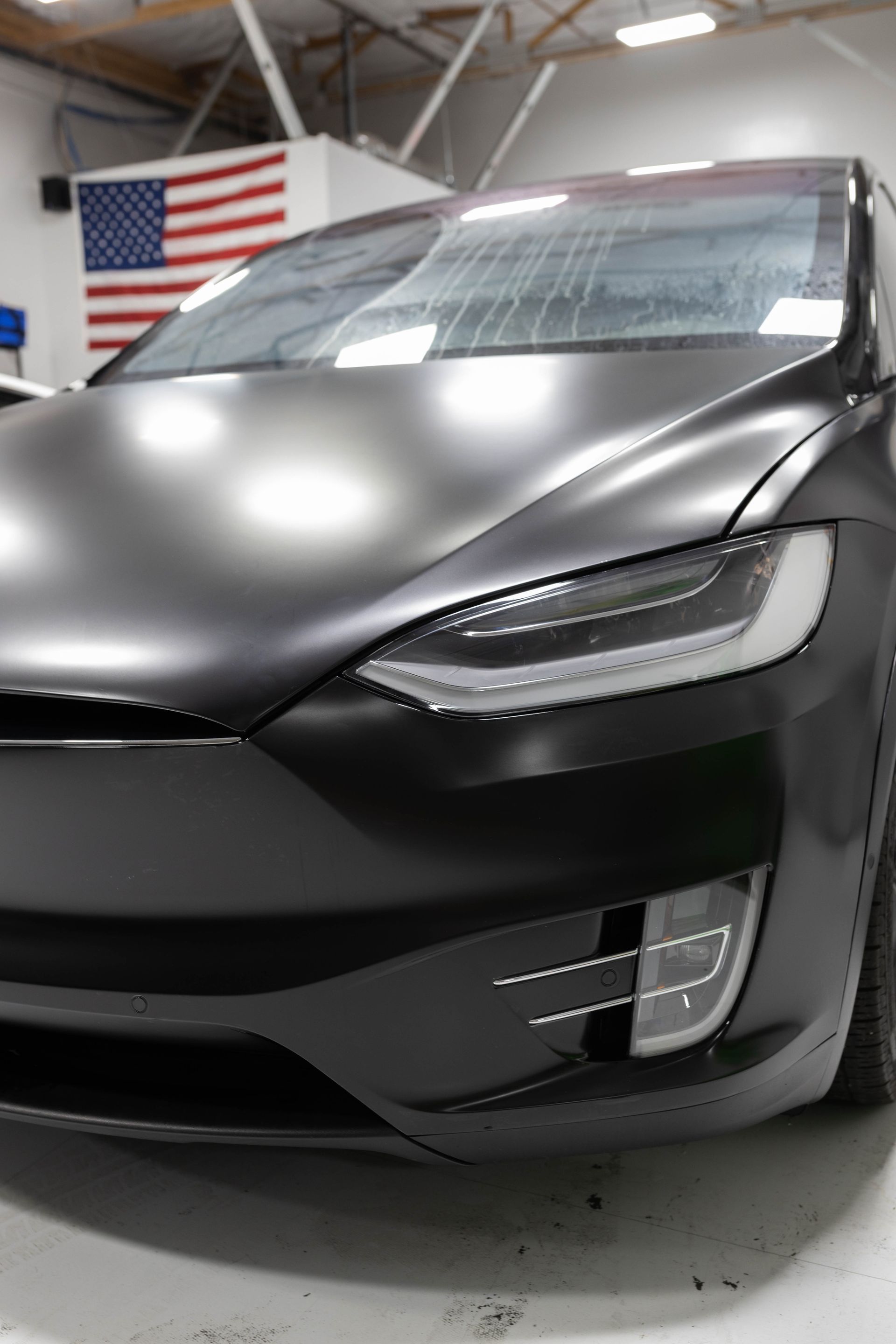 a black car is parked in a garage