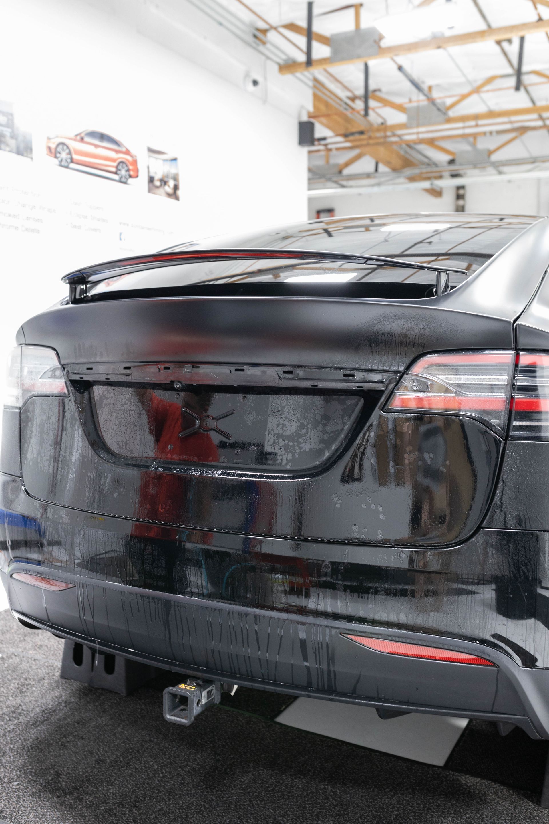 a black tesla is parked in a garage