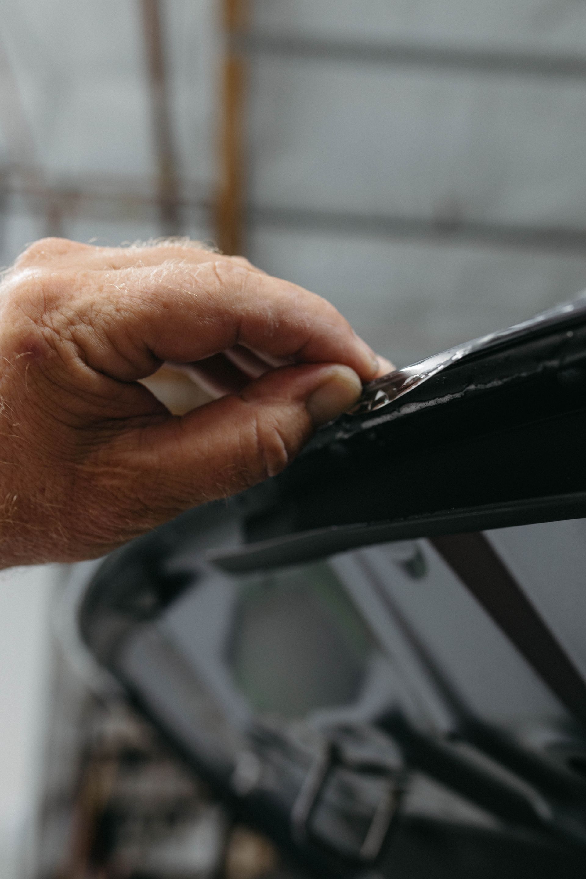 a close up of a person 's hand fixing the edges of a protective film
