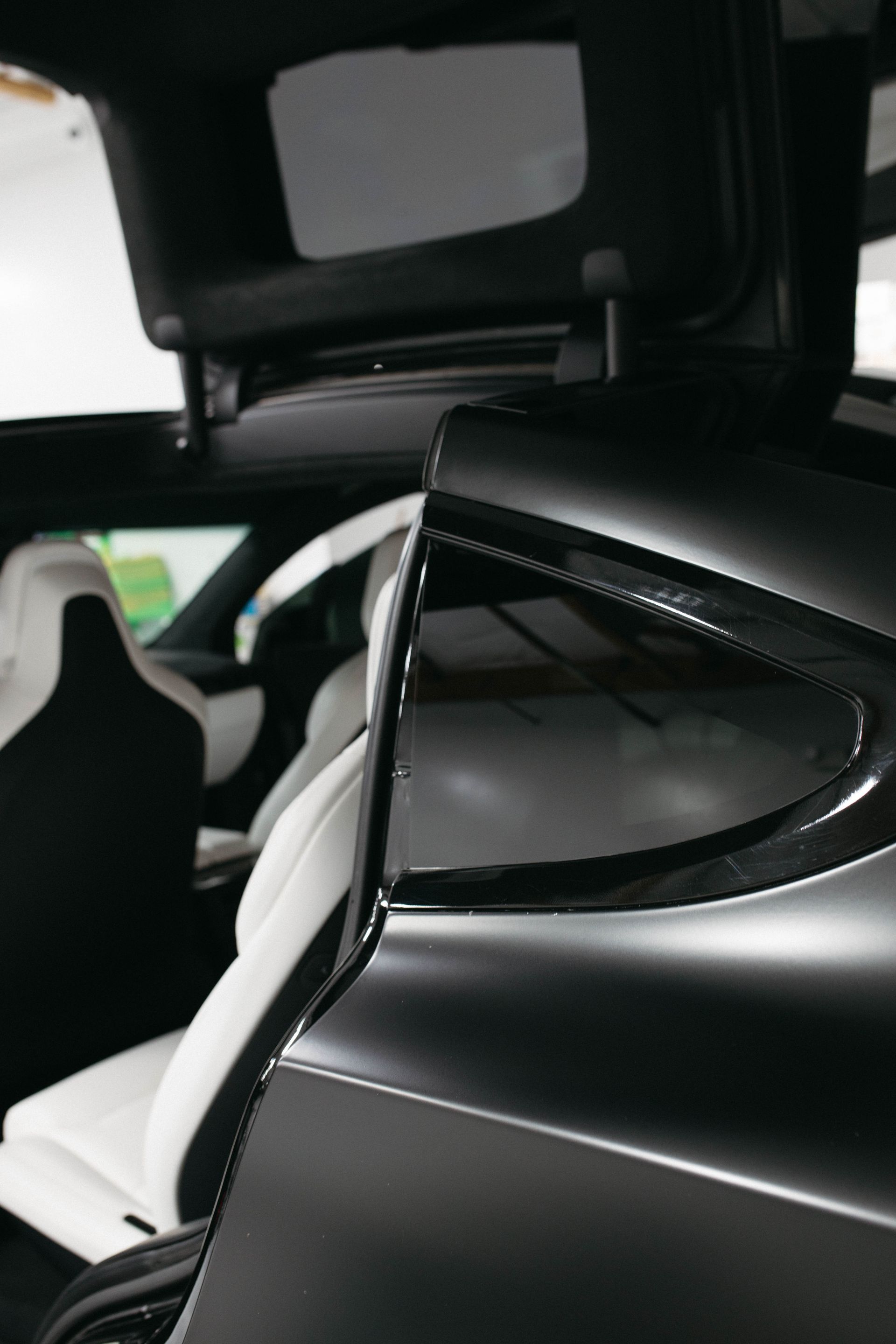 a black car with a white seat and a sunroof