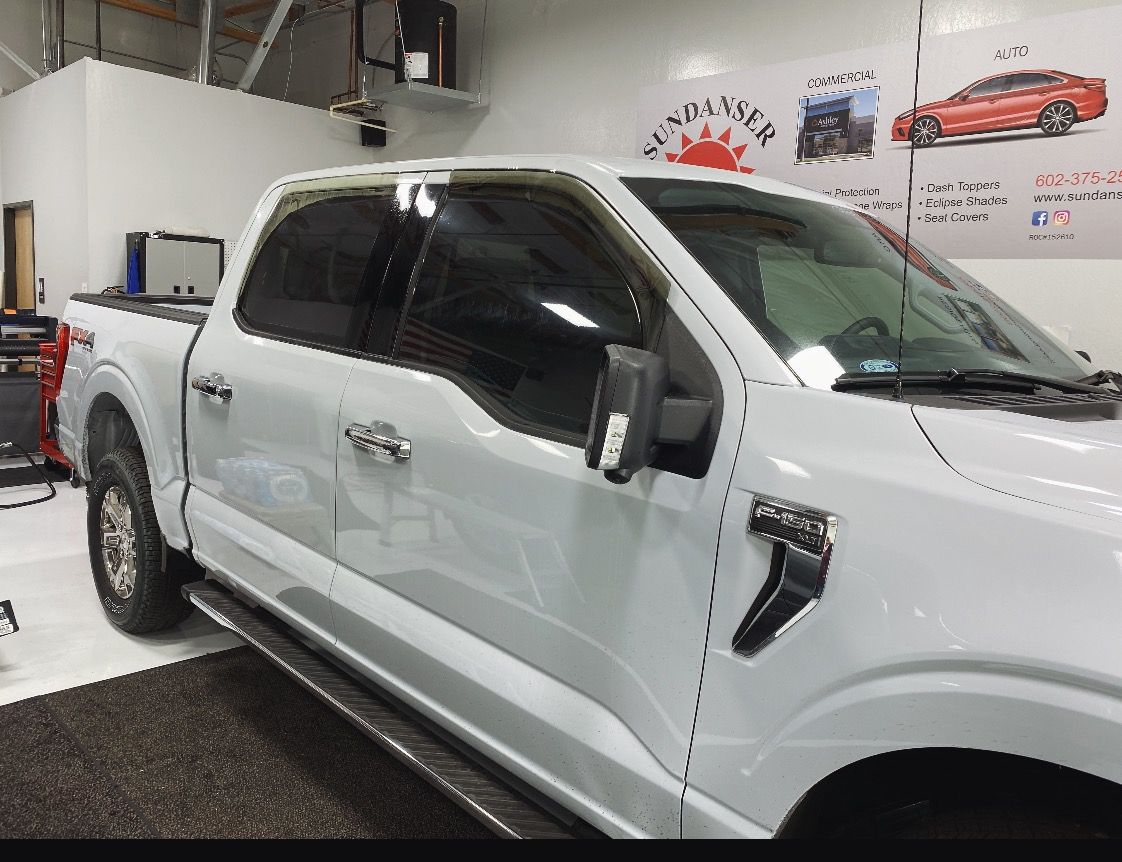 a white pickup truck is parked in a garage