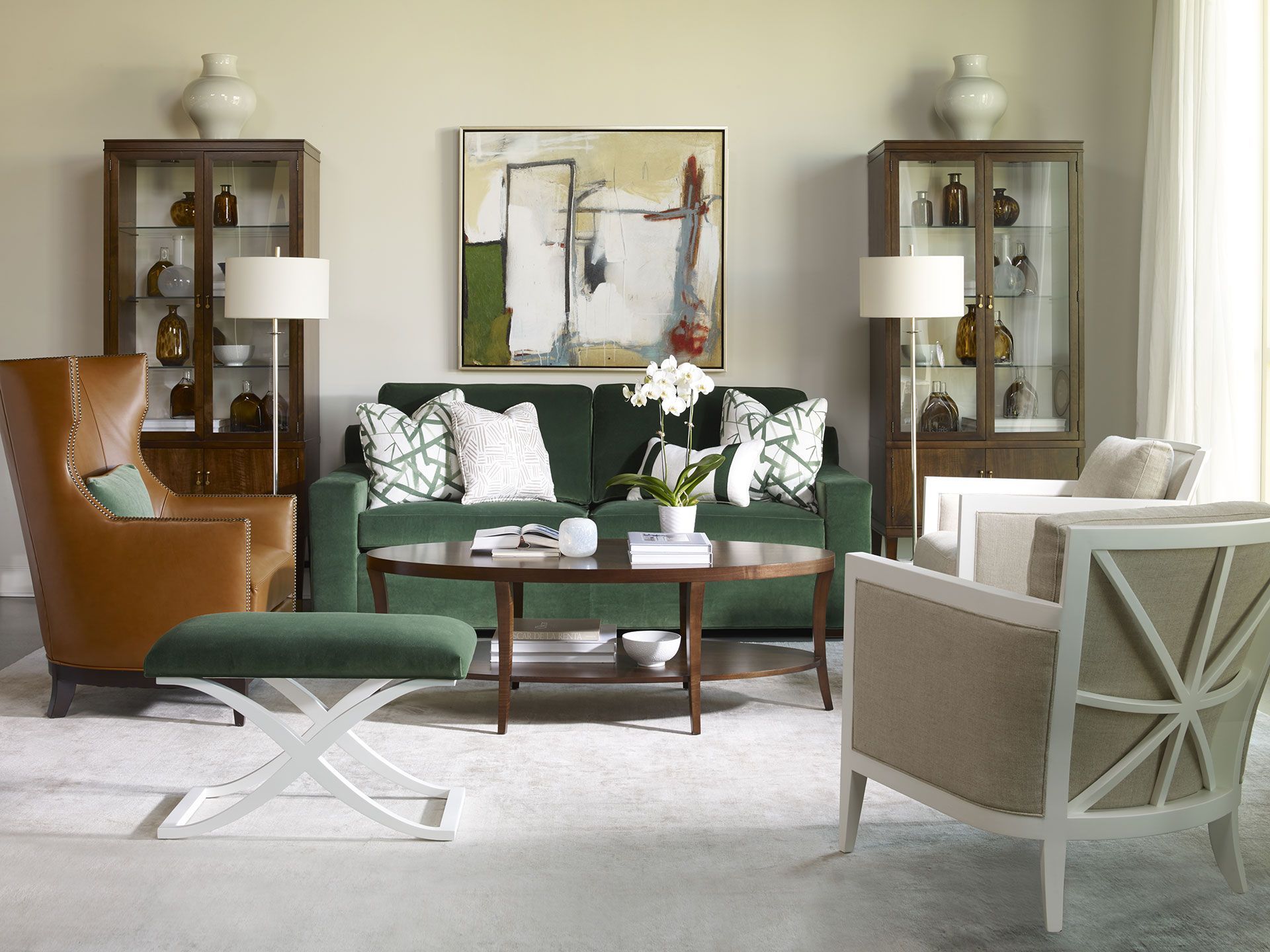 A living room with a green couch and two chairs