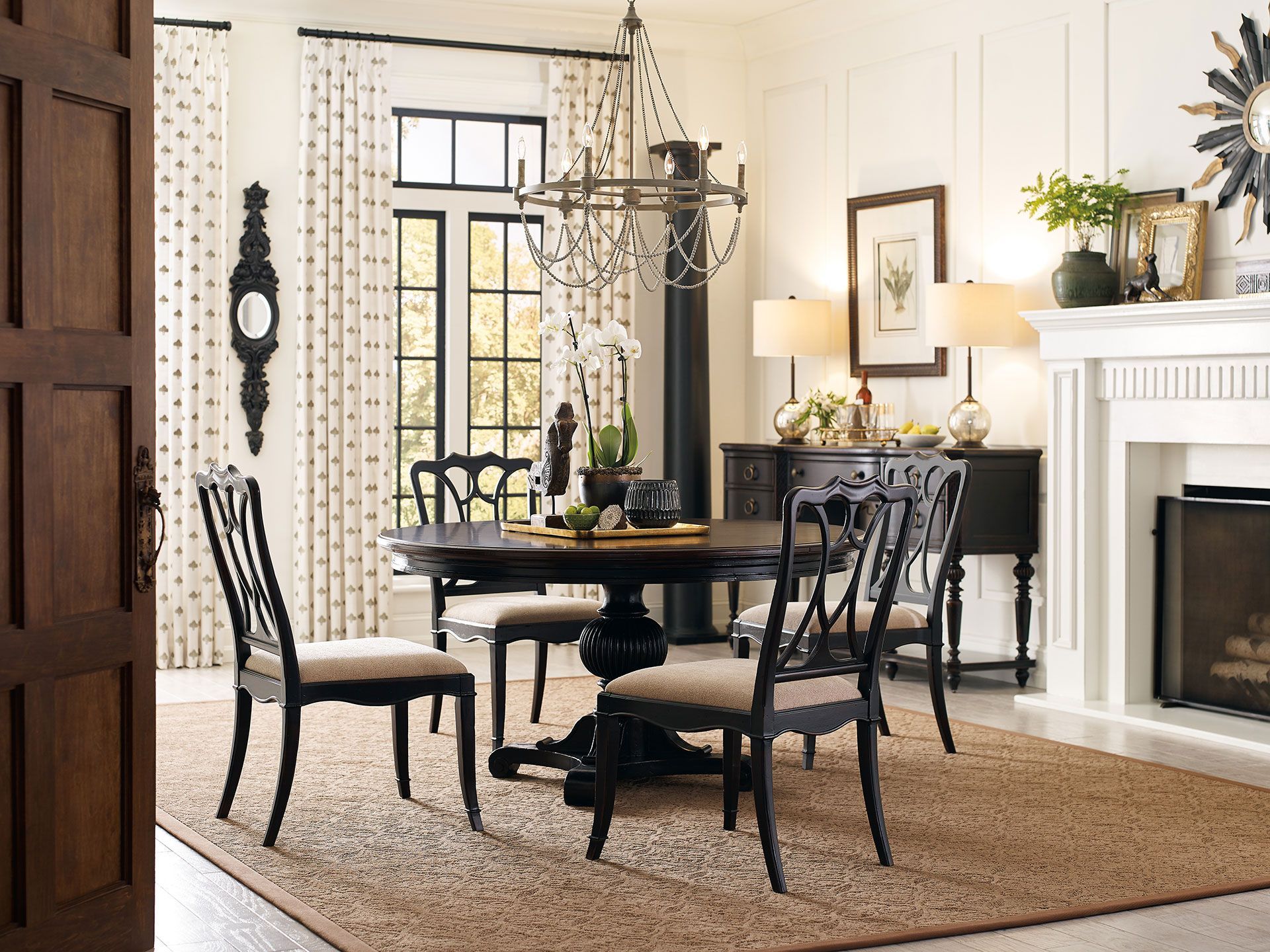 A dining room with a table and chairs and a fireplace