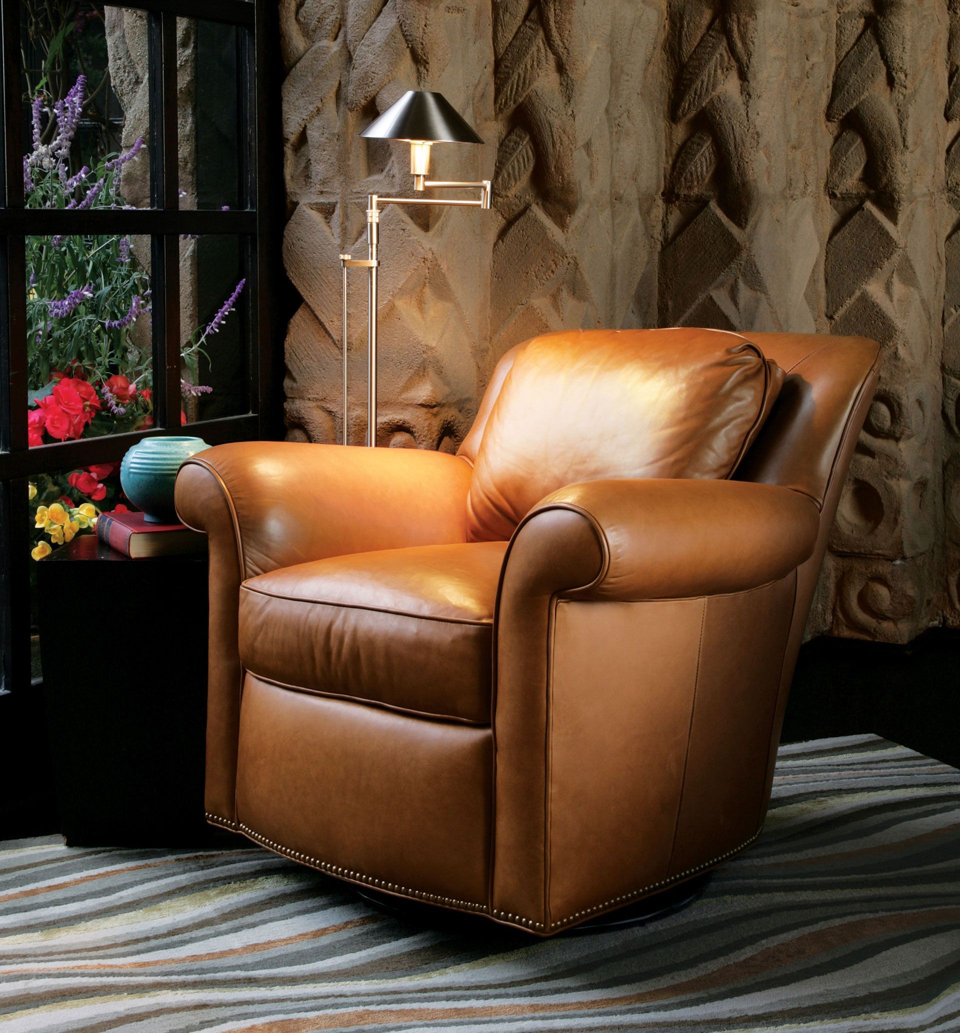 A brown leather chair is sitting in front of a window