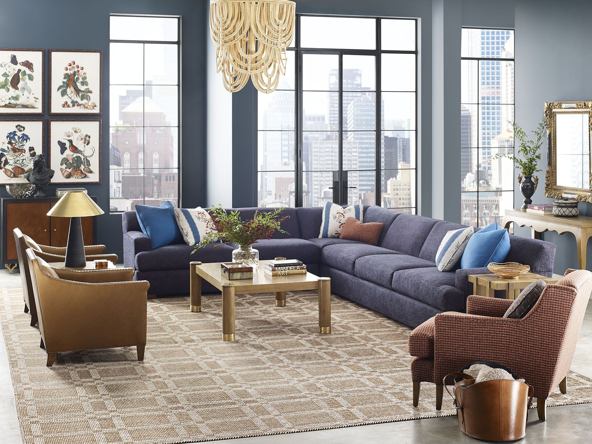 A living room with a large sectional couch , chairs , and a coffee table.