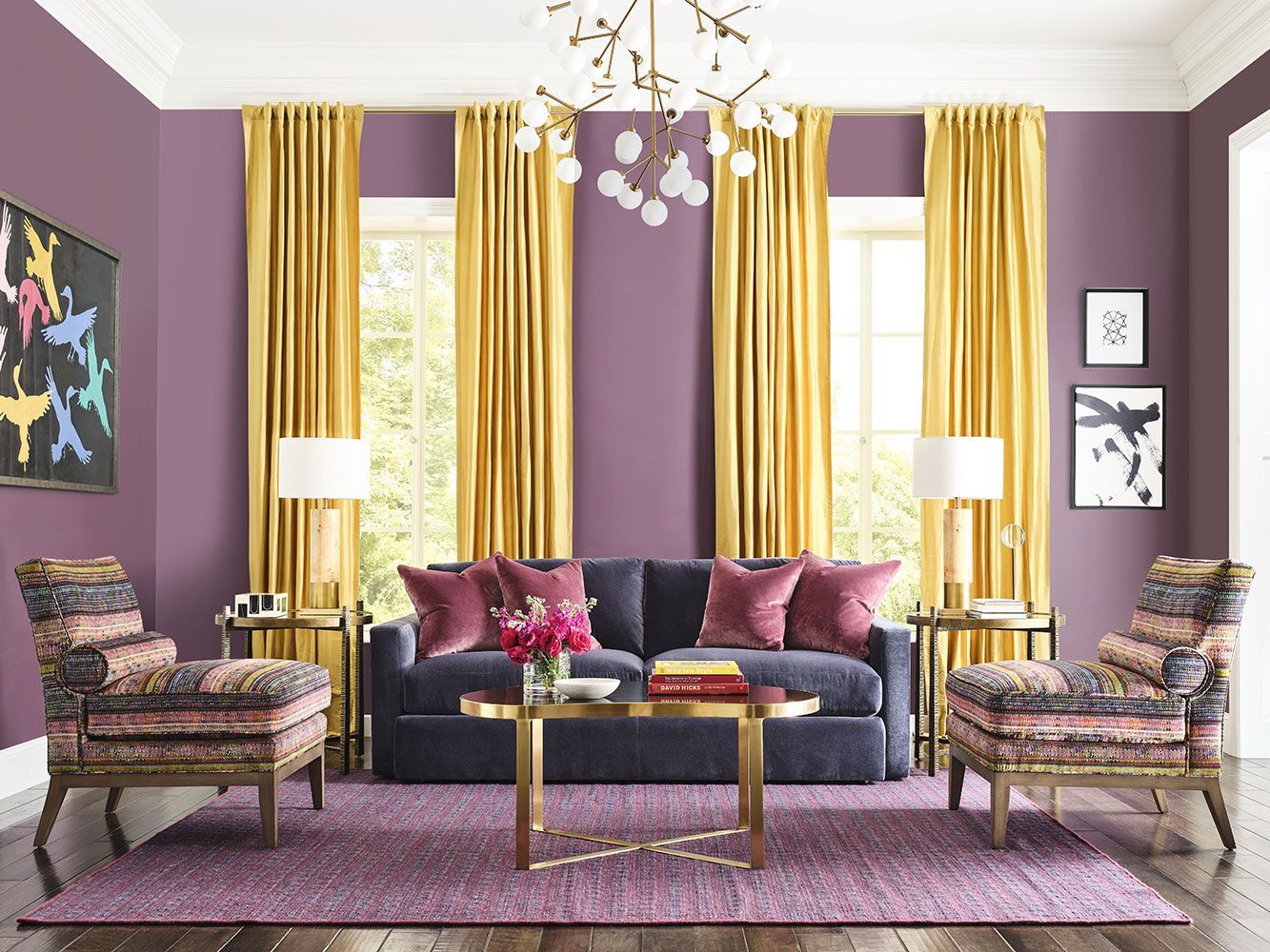 A living room with purple walls and yellow curtains