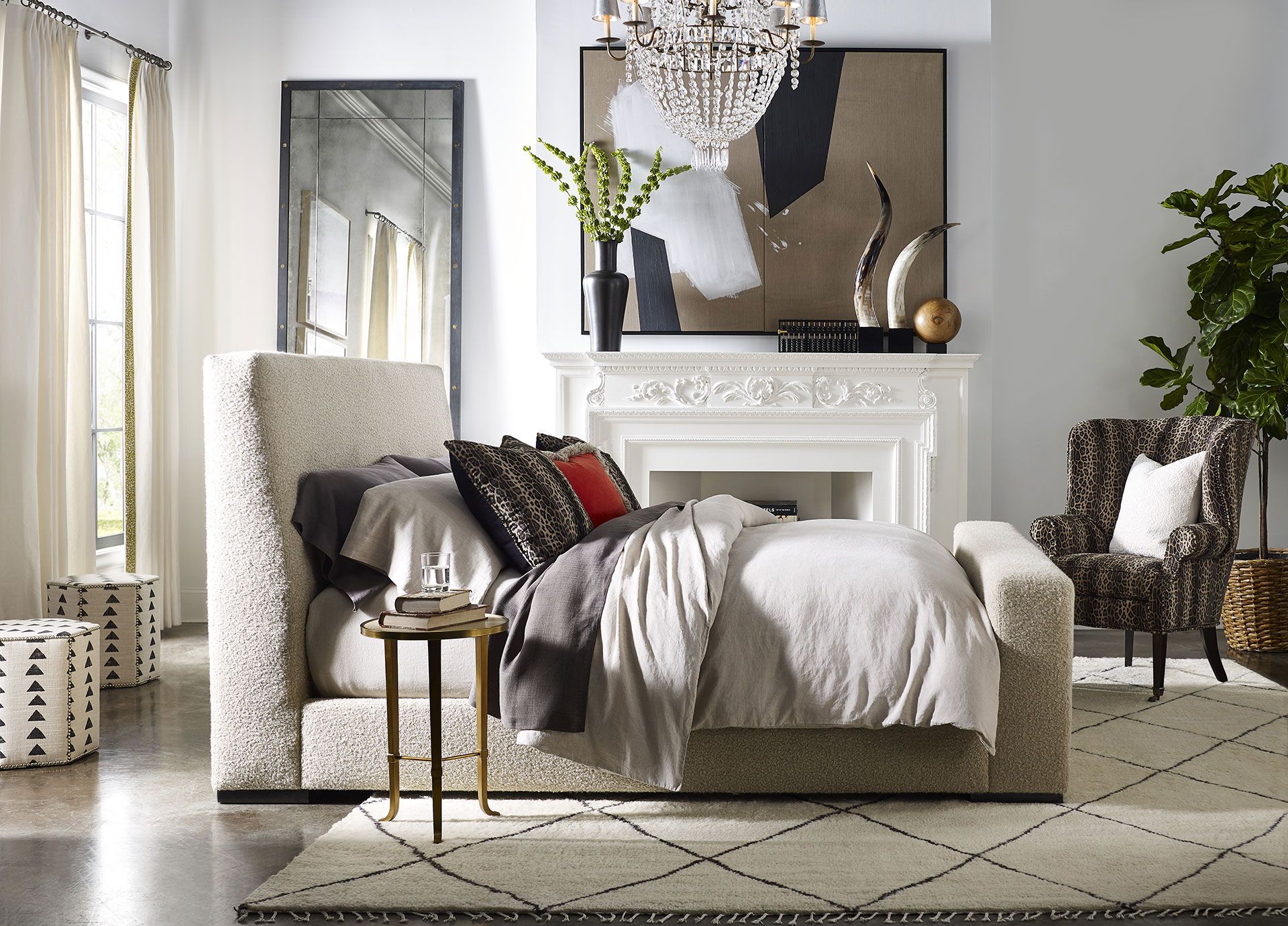 A bedroom with a large bed and a fireplace