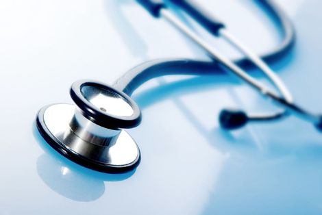 Two stethoscopes on a blue surface, suggesting a medical setting