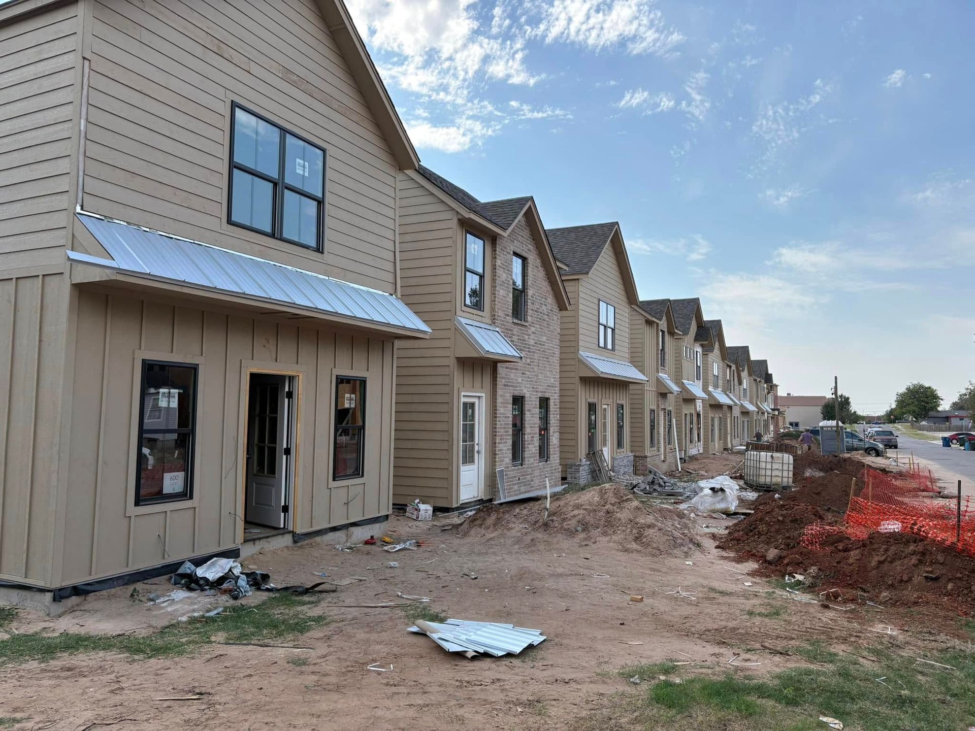 A row of houses are being built in a residential area.