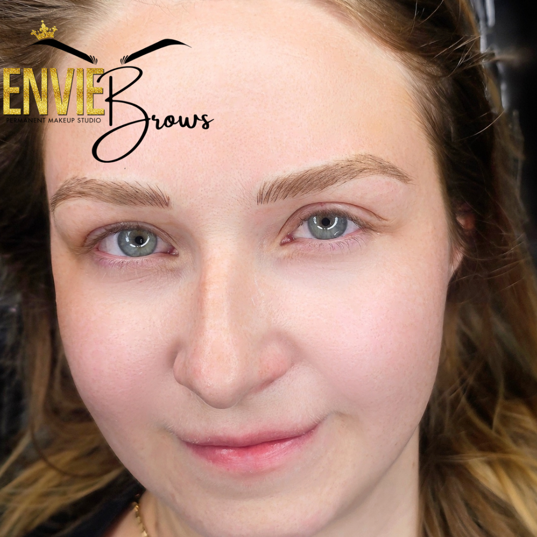 A close up of a woman's face with envy brows written on her forehead