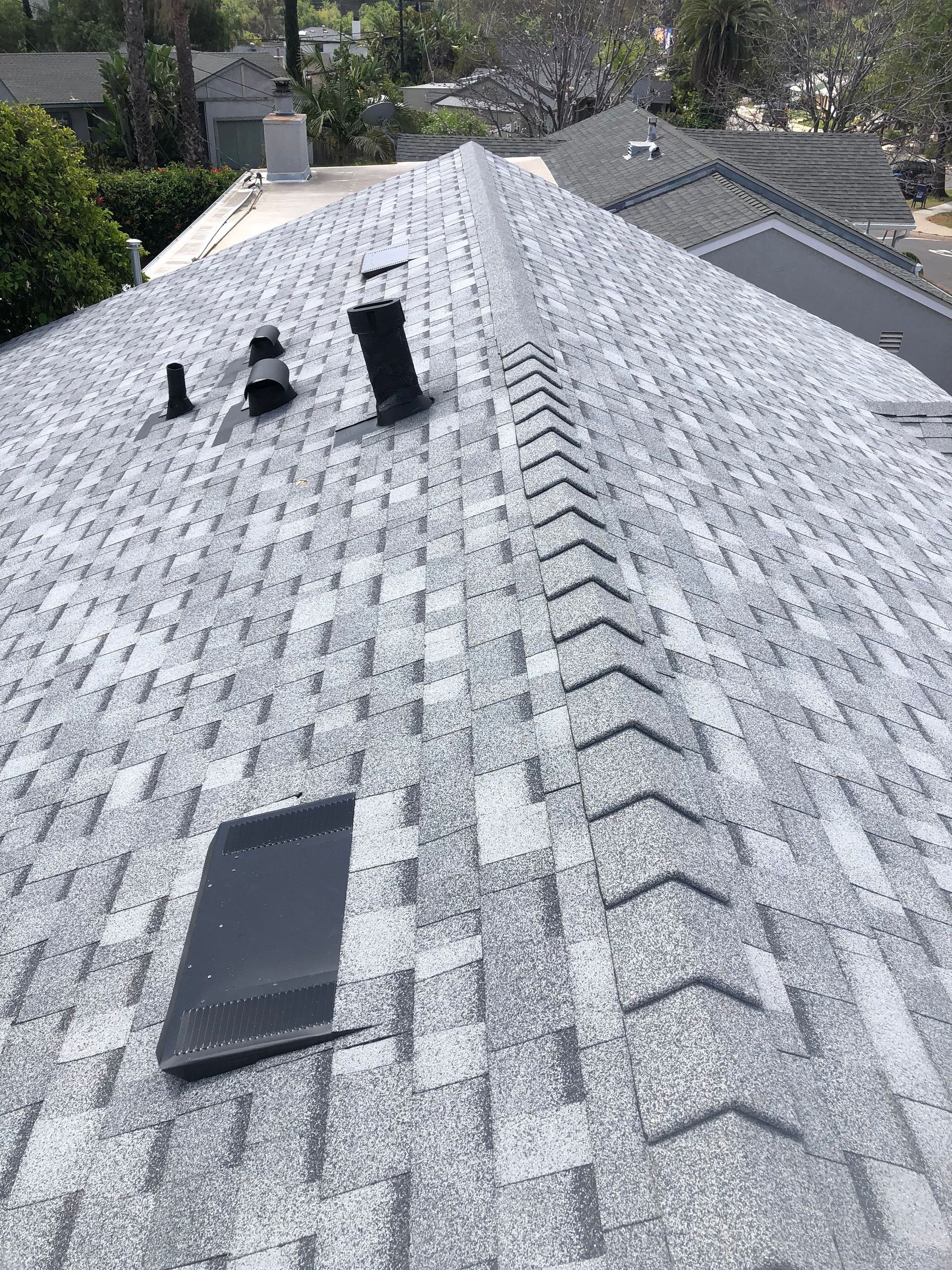 A close up of a roof with a vent on it.