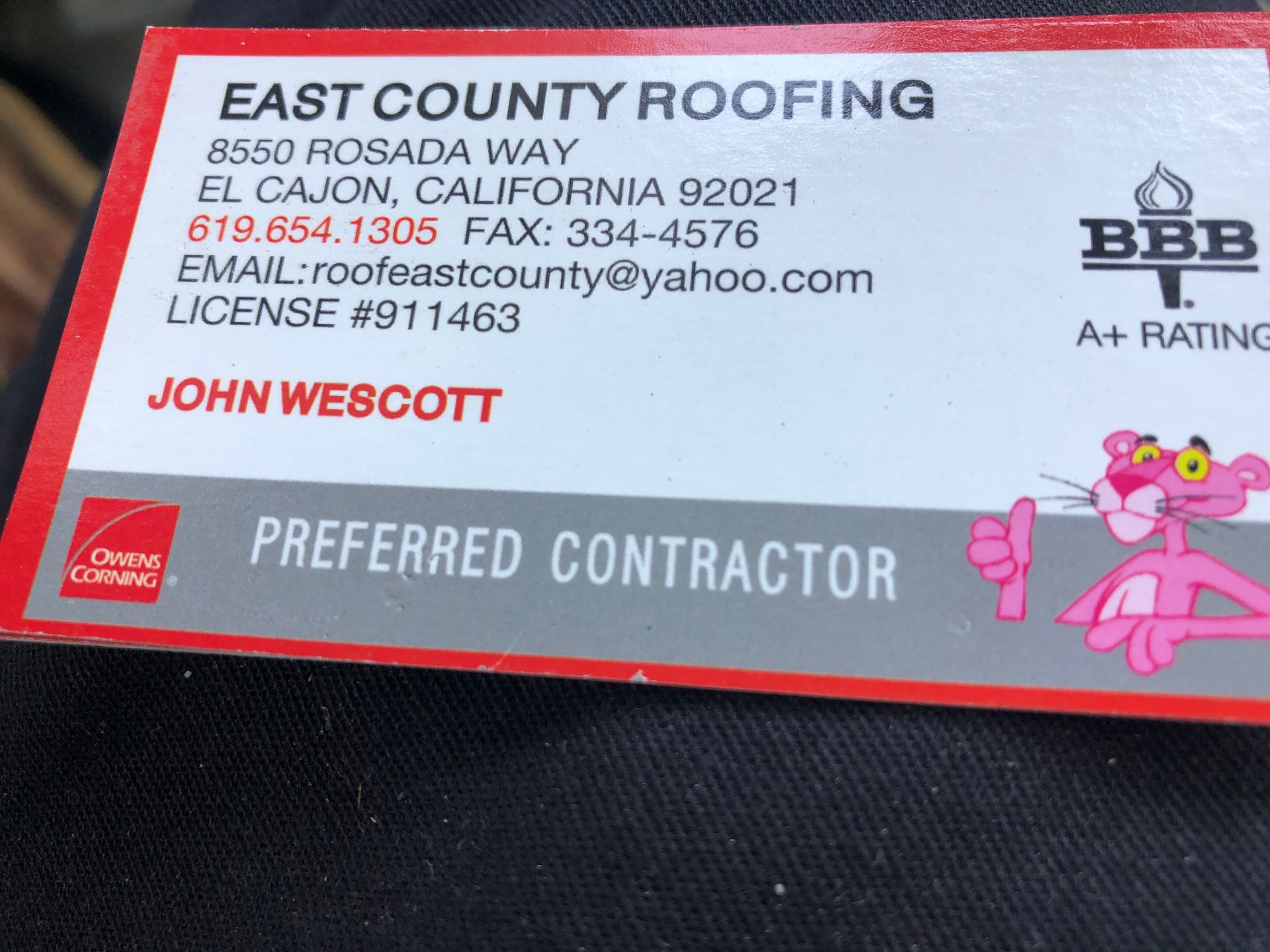 A business card for east county roofing has a pink panther on it