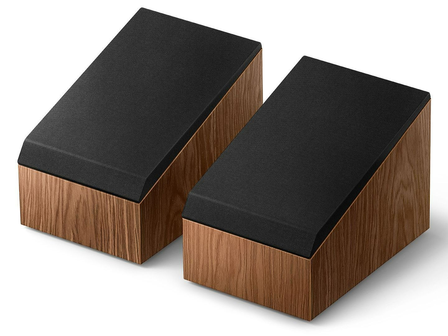 A living room with a couch , television , speakers and a coffee table.