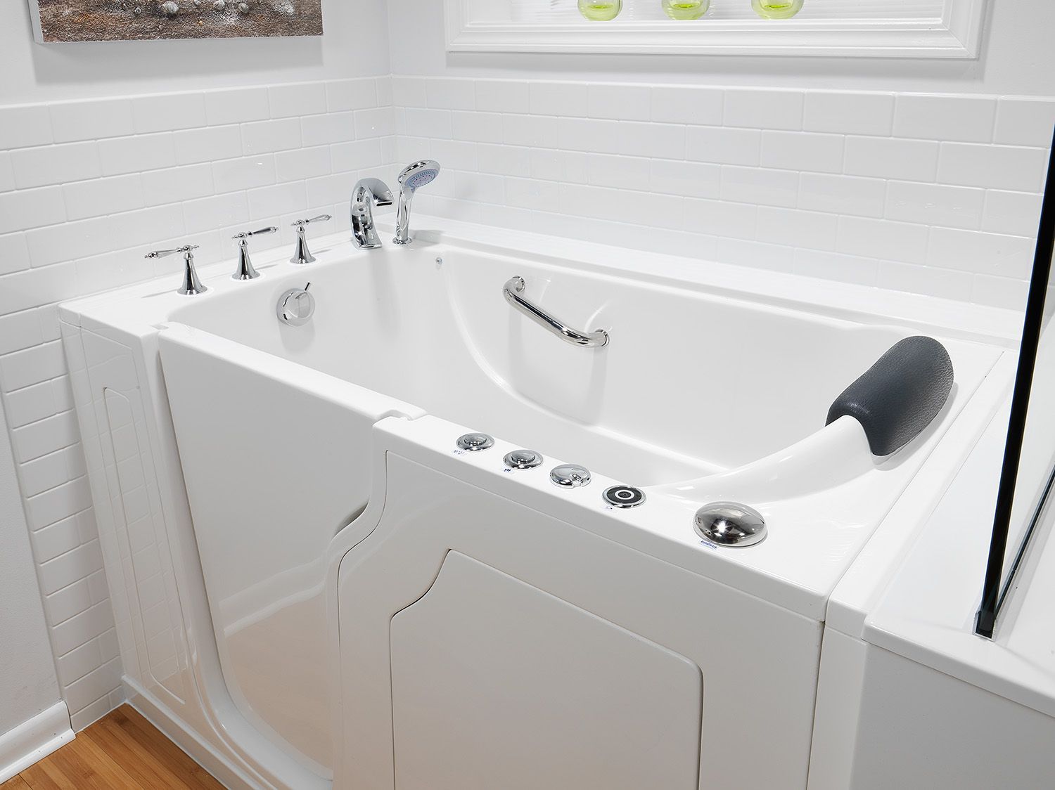 White walk-in bathtub with chrome fixtures and built-in grab bars in a bright bathroom