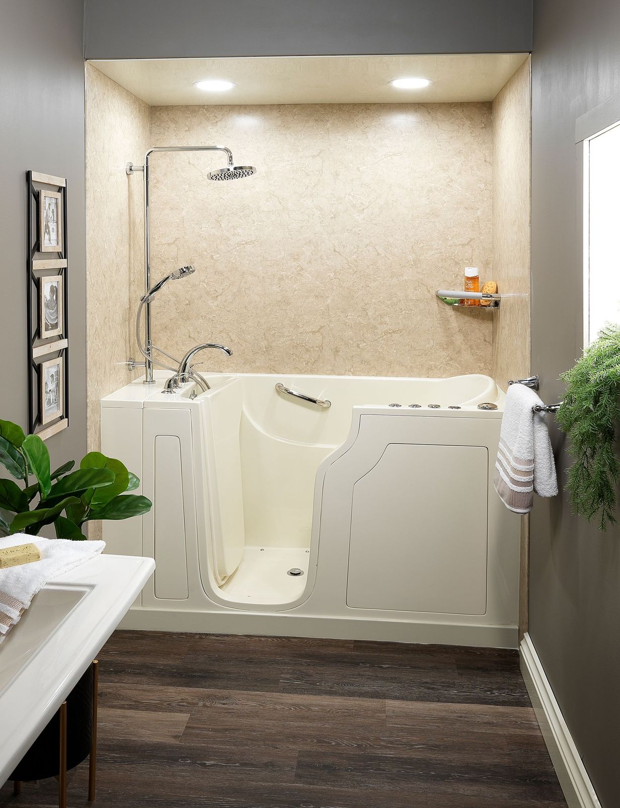 Accessible bathroom with a walk-in tub, shower fixtures, and wood-look flooring