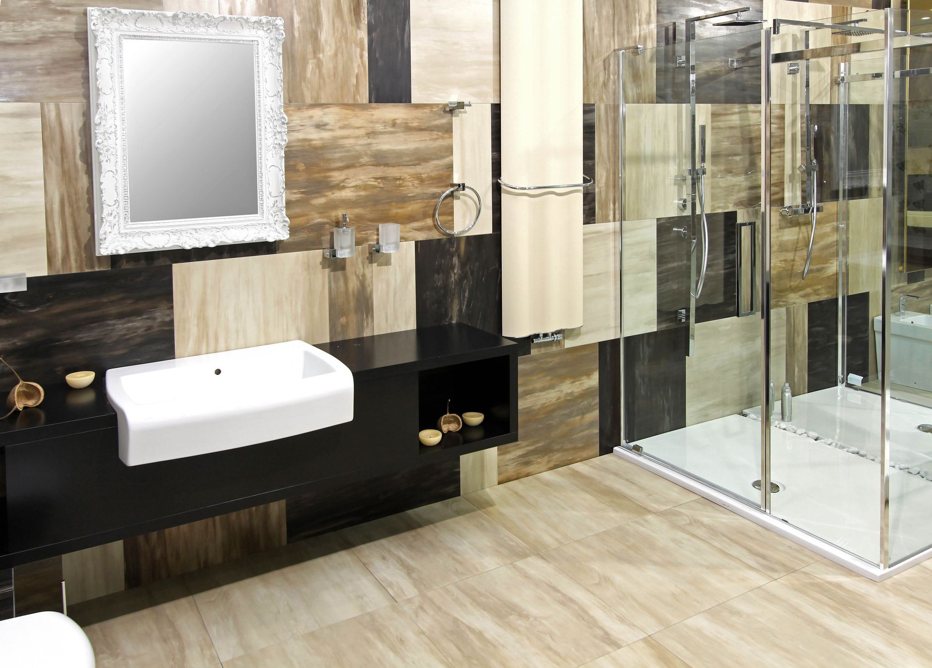 Modern bathroom with white sink, ornate mirror, wood accents, and glass shower enclosure