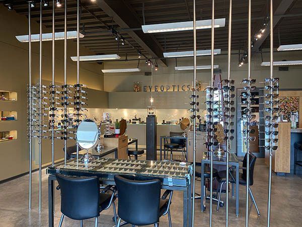 Beauty salon interior with mirrors, styling chairs, and glass shelves of hair products