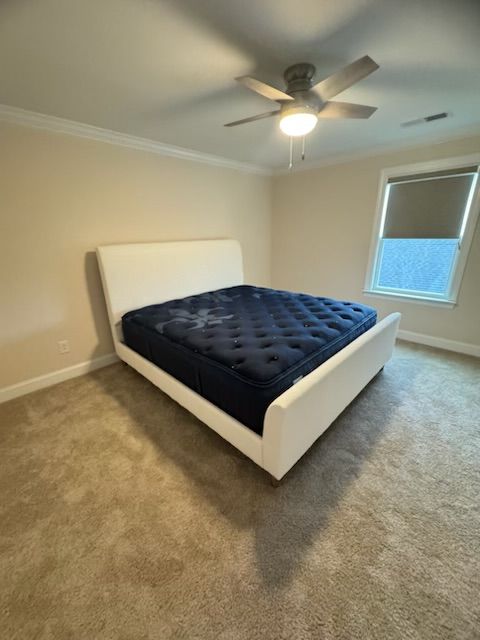 A bedroom with a bed and a ceiling fan