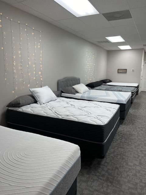 A row of mattresses are lined up in a room