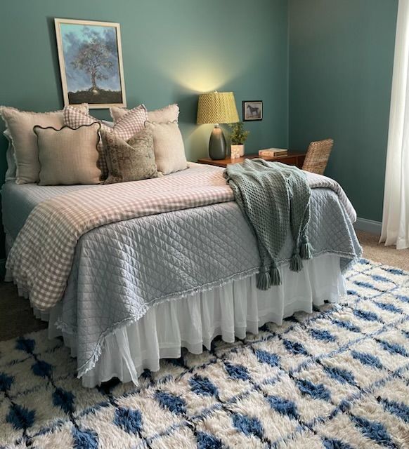 A bedroom with a large bed and a rug