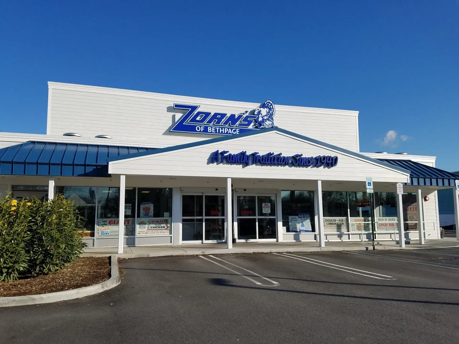 Zorny's Family Kitchen Storefront, blue and white building with sign, under a clear, sunny sky.