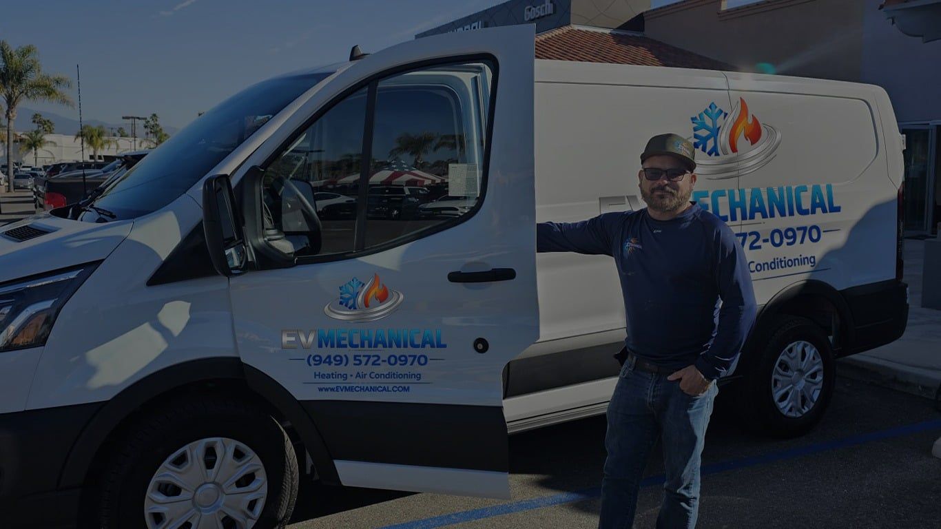 Man standing beside a white utility van with open door and company logo in a parking lot