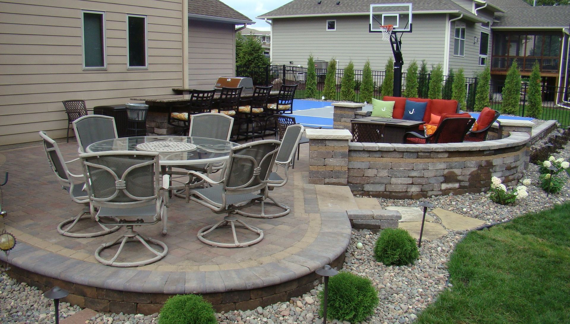 Backyard patio with dining area, bar, and fire pit.