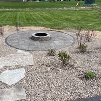 There is a fire pit in the middle of the yard.