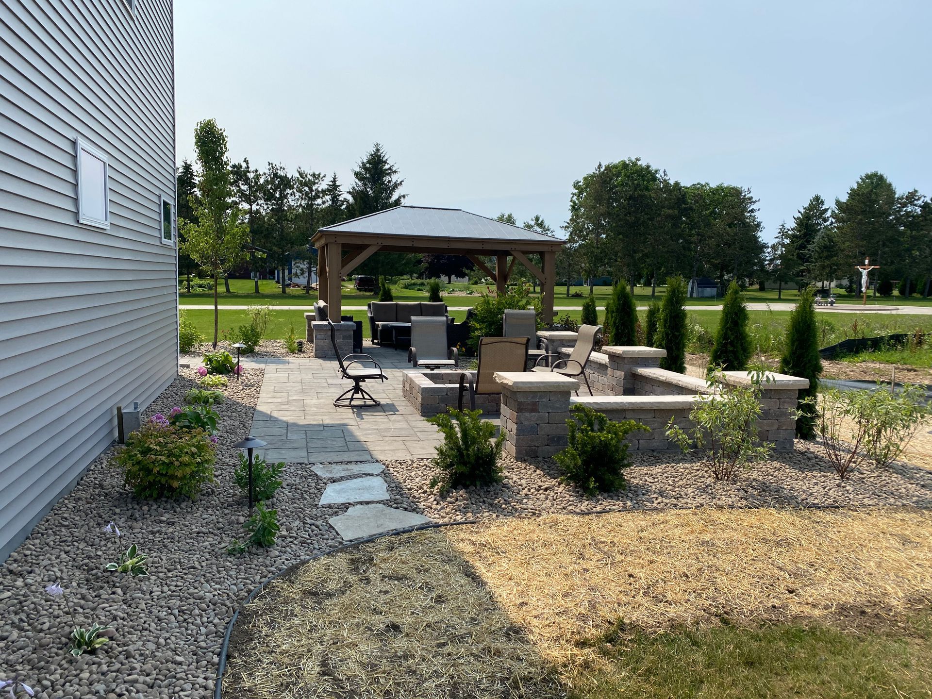 There is a gazebo and a fire pit in the backyard.