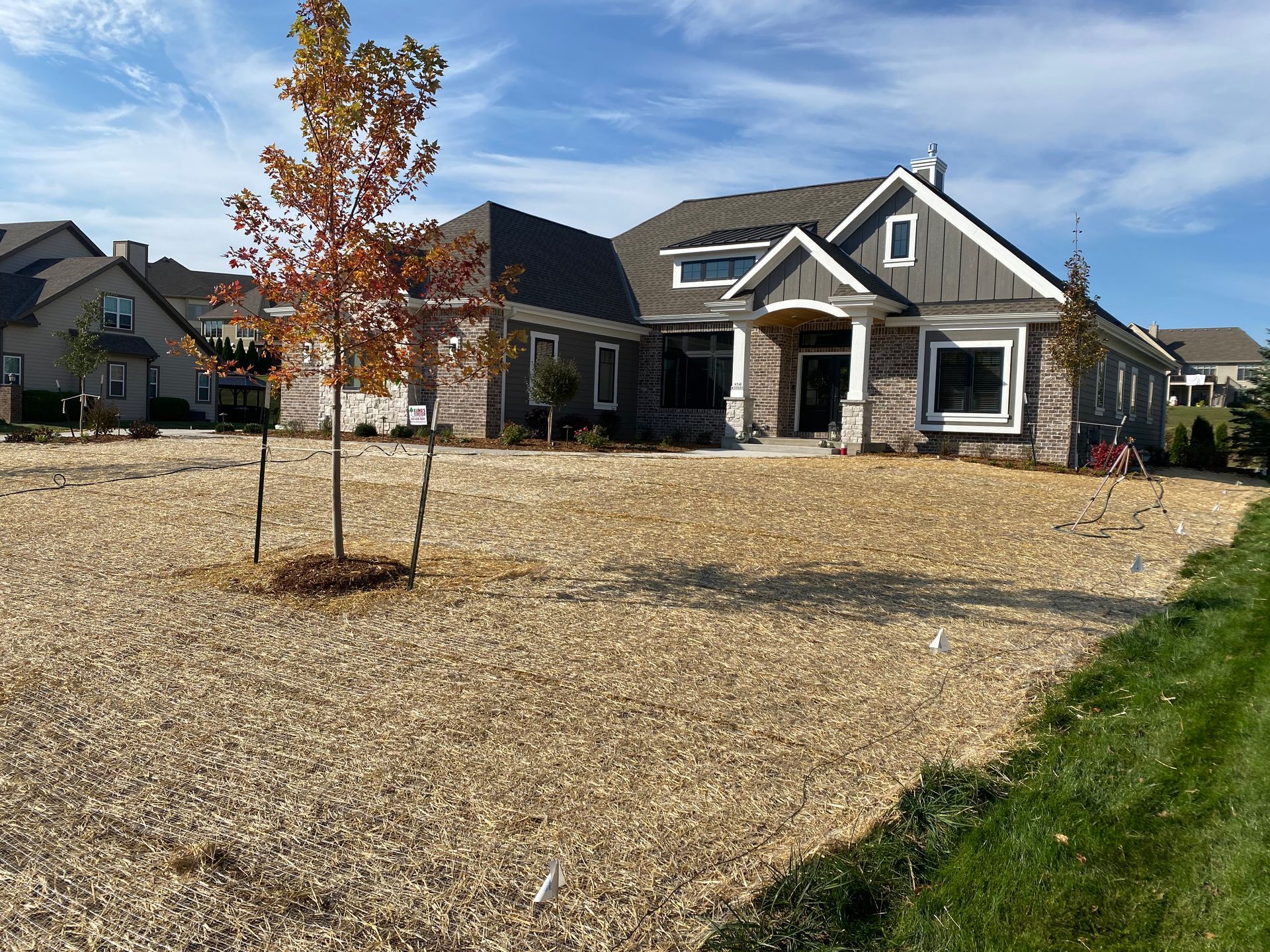 A large house with a lot of gravel in front of it.