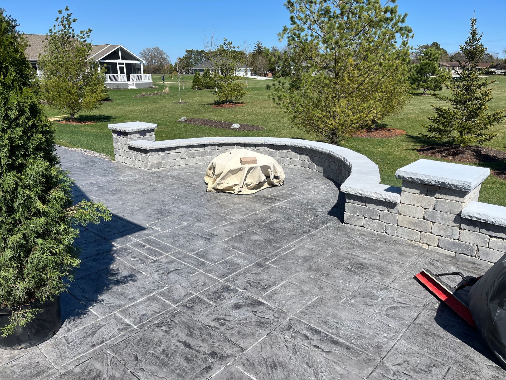 There is a fire pit in the middle of the patio.