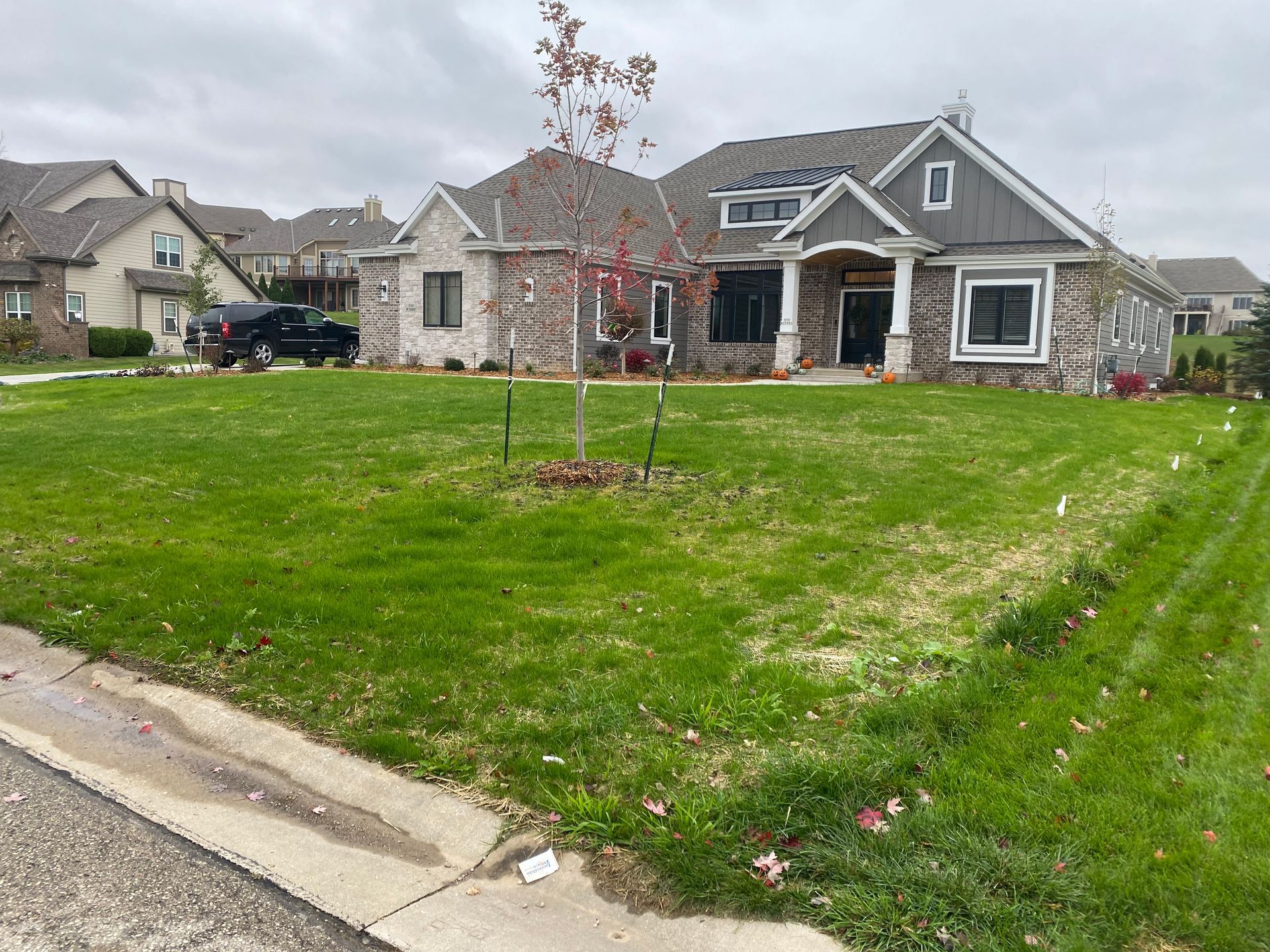A large house with a lush green lawn in front of it.