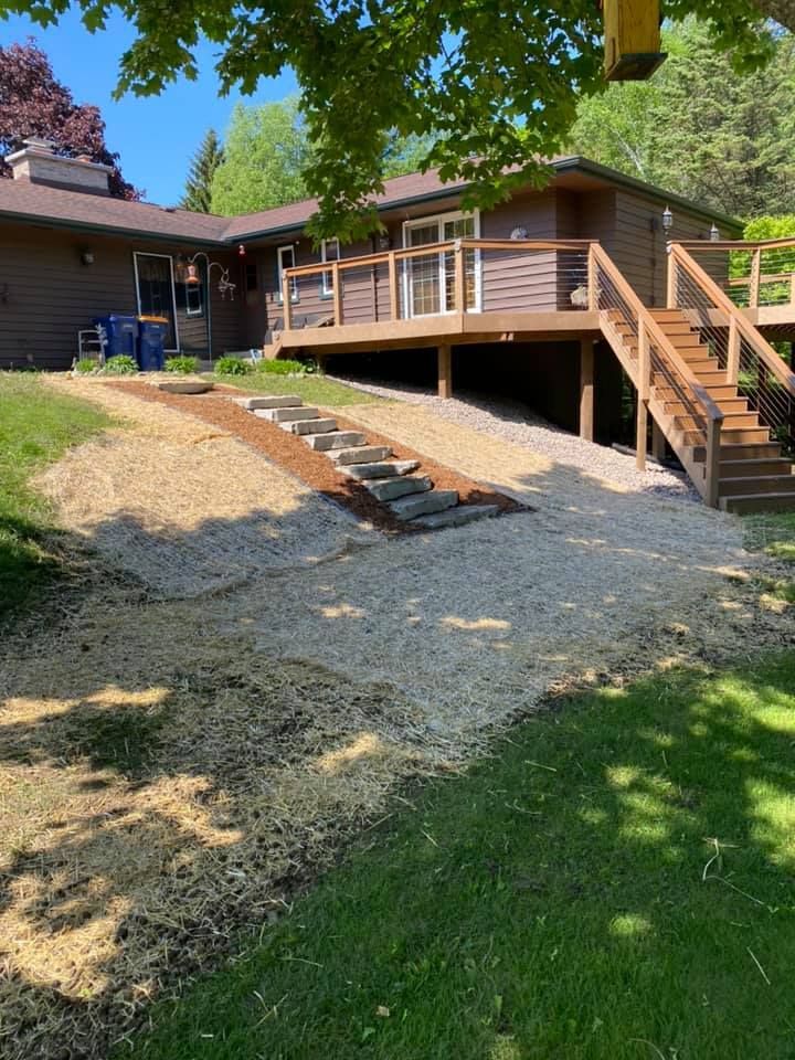 A house with a large deck and stairs leading up to it.