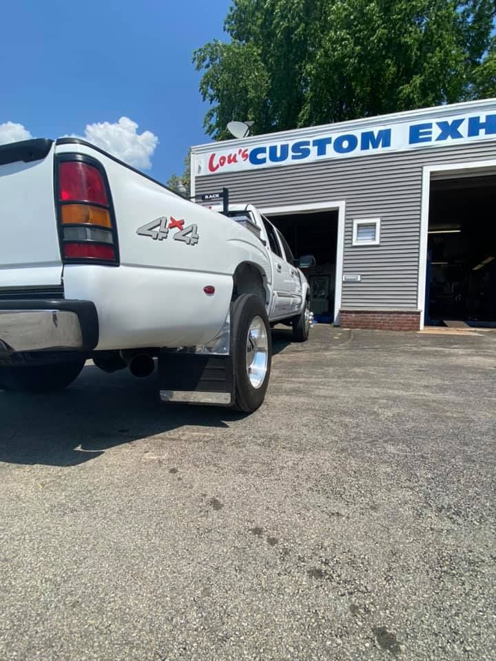 Lou's Custom Exhaust Shop with white pick-up