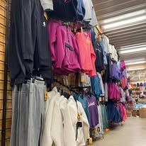 A store filled with lots of clothes hanging on racks