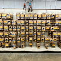 A wall filled with lots of boxes of tools in a store