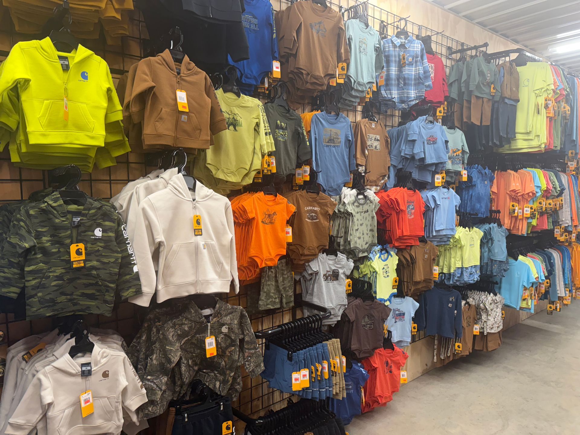 A row of shirts hanging on a wall in a store