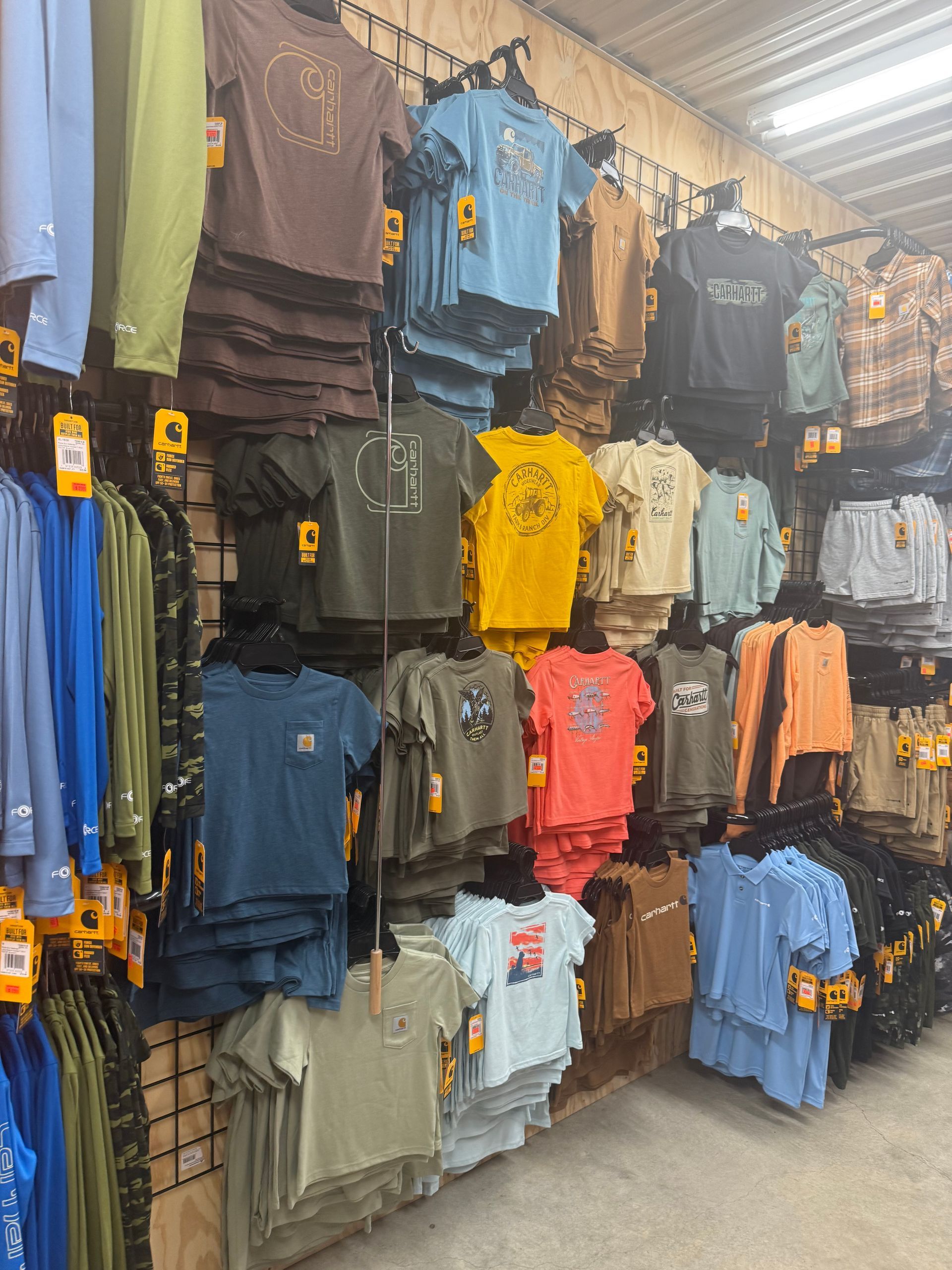 A store filled with lots of shirts hanging on a wall