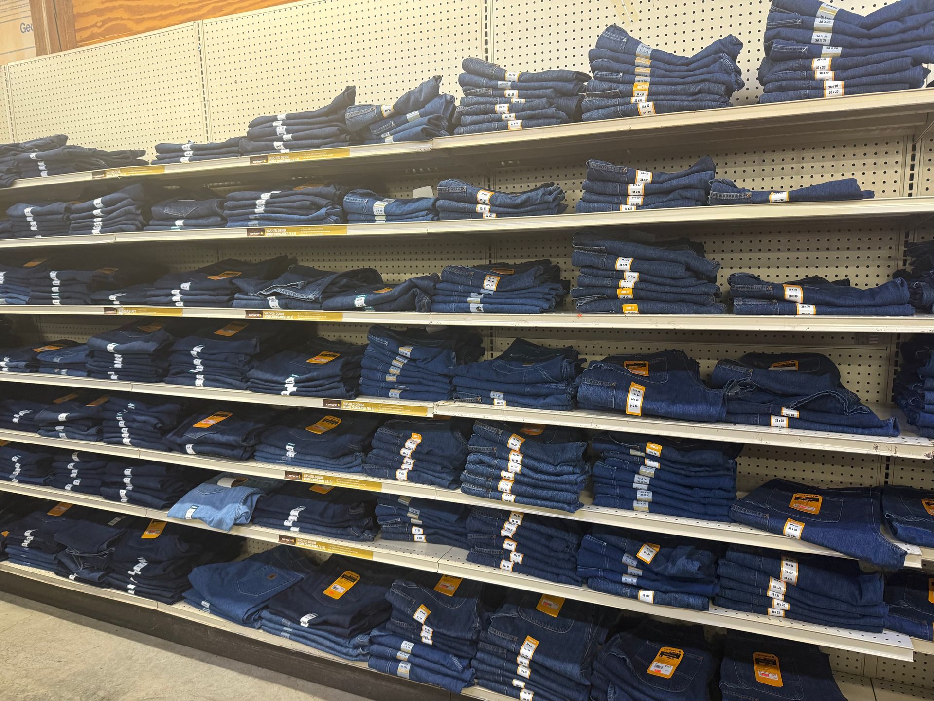 A store shelf filled with lots of blue jeans