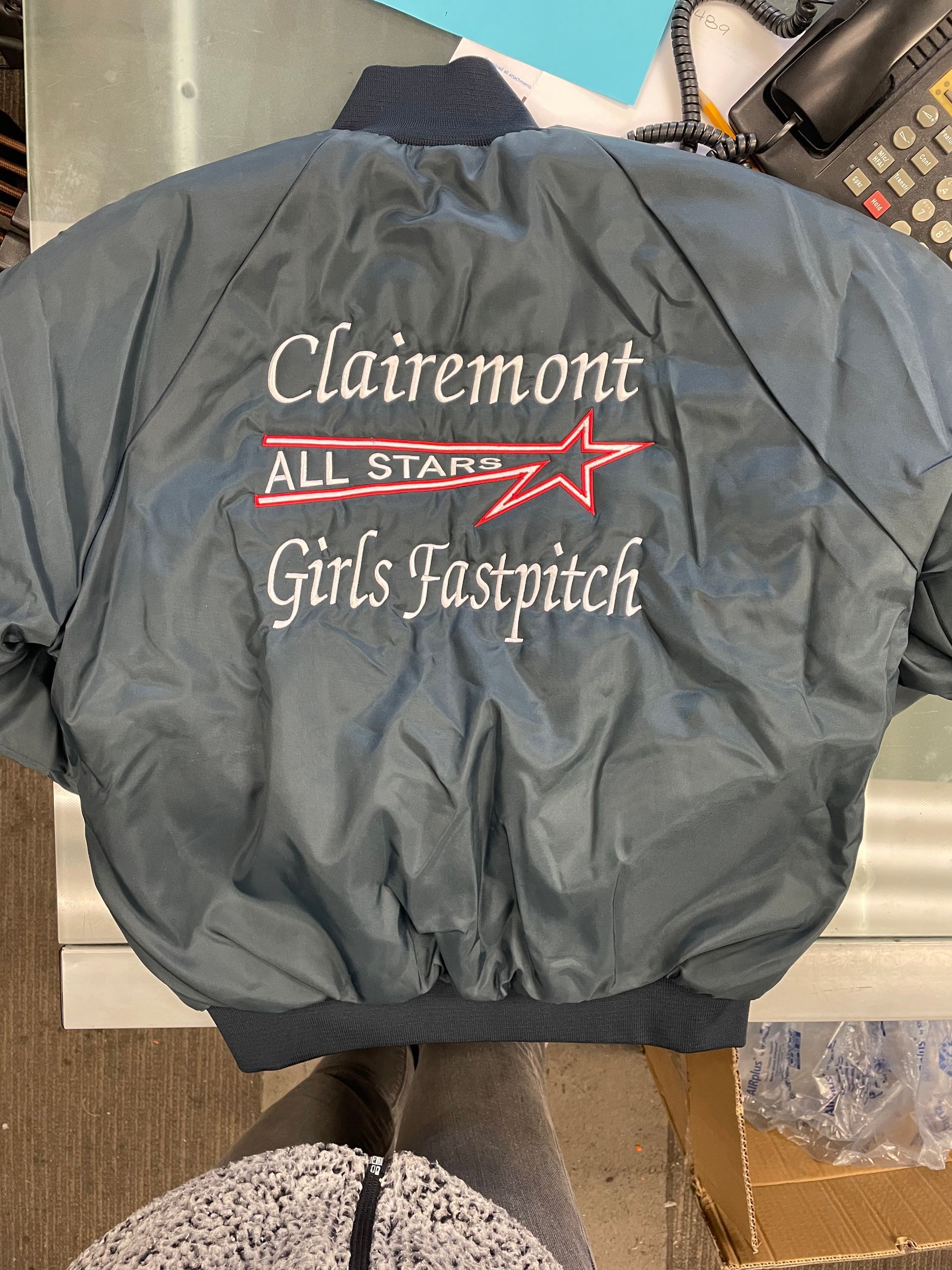 A jacket that says clairemont all stars girls fastpitch