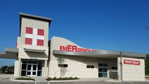 A hospital with a sign that says emergency on it