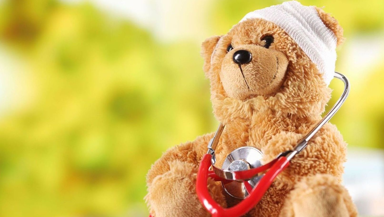 A doctor is listening to a little girl 's heart with a stethoscope.