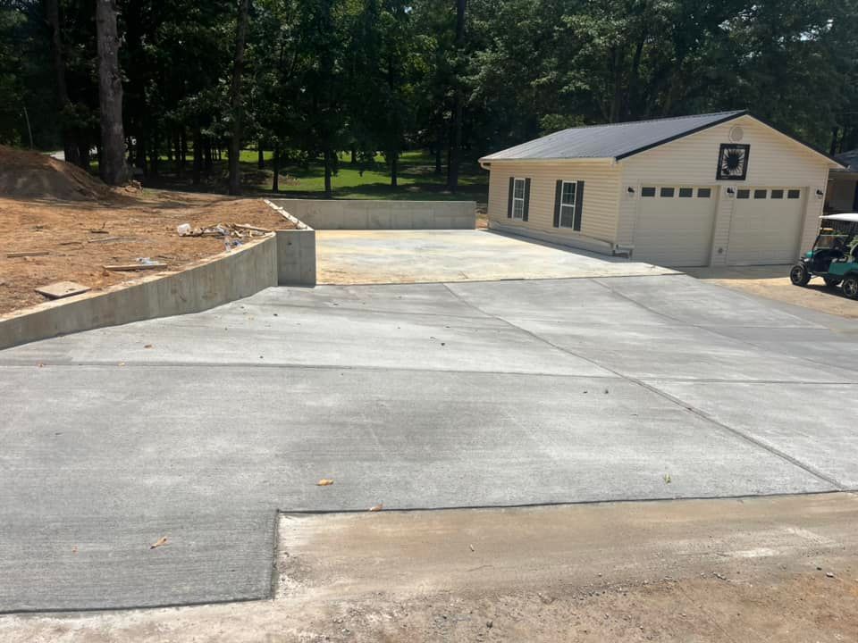 A concrete driveway leading to a house with a golf cart parked in front of it